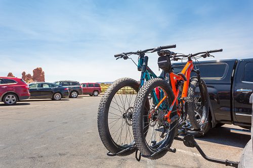 Bikes loaded on the back of a car.